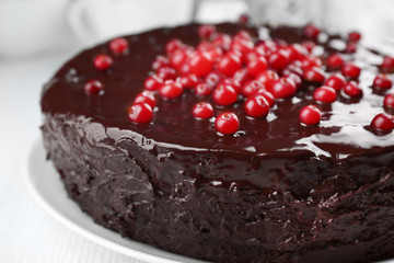 Chocolate cake with cranberries on plate, closeup