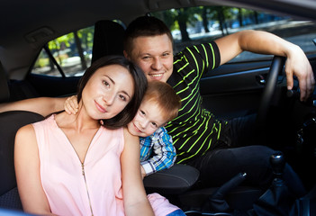 Family sitting in the car looking out windows