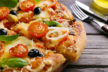 Delicious fresh pizza on wooden table closeup