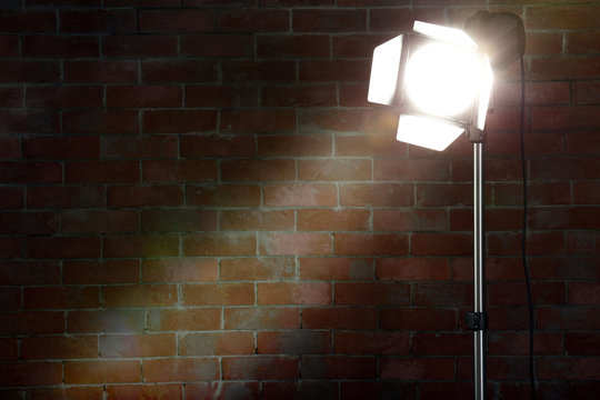 Studio light flash on brick wall background