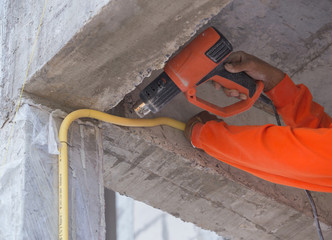 Hand use a heat gun to bending electric PVC pipe