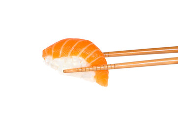 Salmon sushi between two choptsicks islated on white background