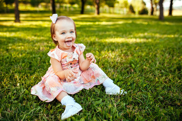 Cute little girl on the meadow in summer day.