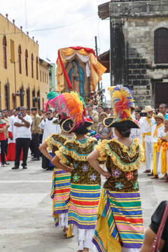 Leon, Nicaragua - December 12, 2015: Aborigen dancers in typical dress celebrating on the street