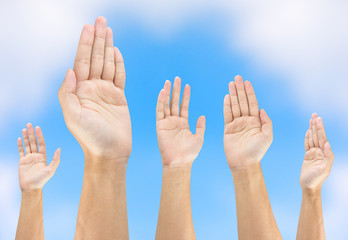 people raise hand on sky background