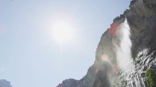 Switzerland alps waterfall Staubbach falls in Swiss alpine nature landscape in Lauterbrunnen valley. Tourist attraction destination and landmark in Bernese Oberland, Schweiz, Europe. SLOW MOTION.