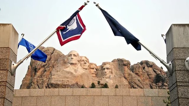 Mount Rushmore in South Dakota with state flags waving in the wind
