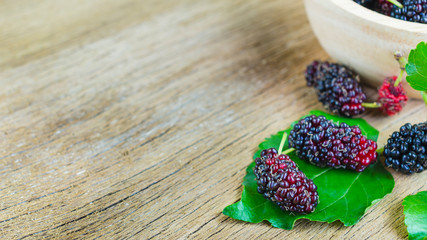 Mulberry with leaf on wooden background