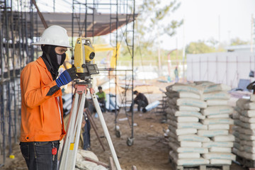 surveyor worker working with equipment at factory construction s