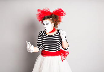 Mime holding cell phone. 