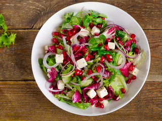 Fresh salad with feta and pomegranate.