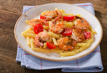 Pasta with shrimps and cherry tomatoes.