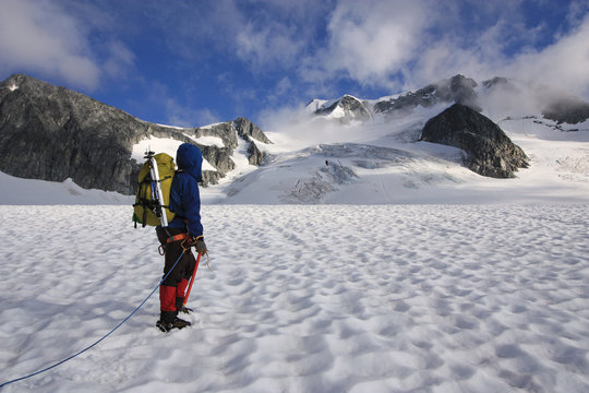 Mountaineer crossing the Wedgemount Glacier in Garibaldi Park of British Columbia, Canada. Wedge Mountain the highest peak in the park in the background.