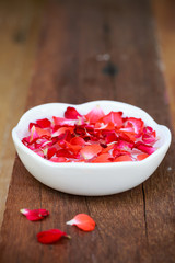 red rose and ceramic  on old wooden
