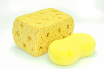 Yellow synthetic sponge on white background.