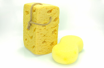 Yellow synthetic sponge on white background.
