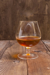 Brandy Glass on a wooden background