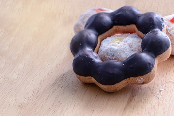 Ring donut glazed with chocolate.