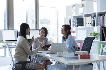 Female company employee teaches work to rookie