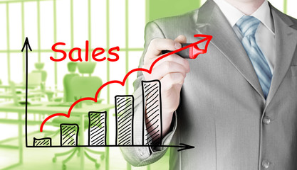 business man drawing graph of sales