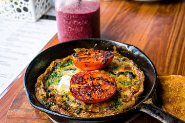 Breakfast meal, omelette with greens and tomato
