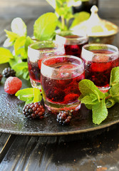berry juice in a glass with berries, selective focus