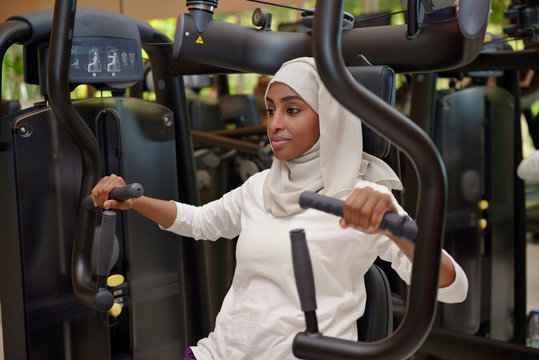 Young arab muslim woman wroking out in a Gym