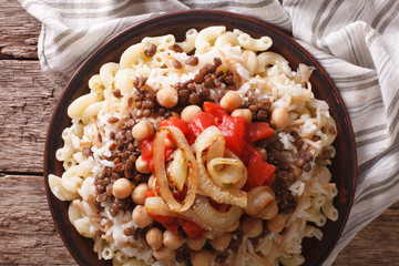 kushari of rice, pasta, chickpeas and lentils close up. horizontal top view
