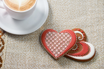 Taste of love. Closeup top view shot of Valentine’s day glazed cookies on the coffee shop table