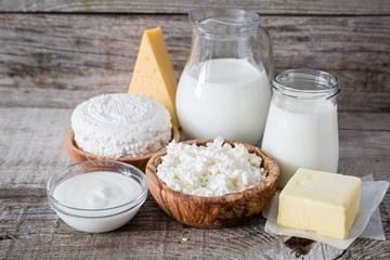 Selection of dairy products on rustic wood bacground
