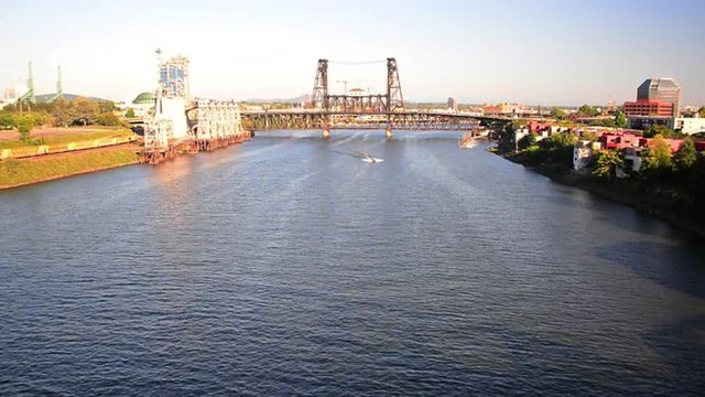 Willamette River in downtown Portland, Oregon with a boat passing under the Steel Bridge
