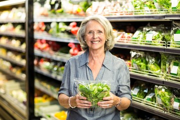 Senior woman picking out some vegetables