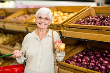 Senior woman picking out some vegetables
