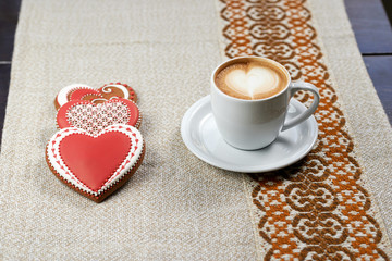 Offering pleasure. Heart shaped cookies with coffee