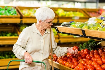 Senior woman picking out some vegetables