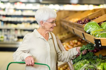 Senior woman picking out some vegetables