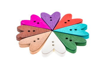 Different color heart shaped sewing buttons in a flower shape.