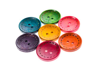 Different color round circular shaped sewing buttons in a flower