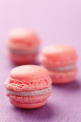 Pink macarons with buttercream filling on pink