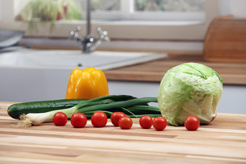 Sliced yellow pepper on wooden cutting board in the kitchen. Vegetables cooking preparations.