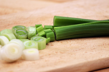 Sliced yellow pepper on wooden cutting board in the kitchen. Vegetables cooking preparations.