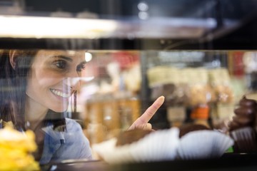 Pretty smiling woman choosing her dessert