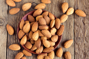 Almonds over rustic wooden background