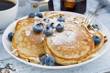 homemade pancakes with blueberries, honey and powdered sugar, cl