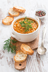 tomato soup with rice and vegetables in a saucepan and bread