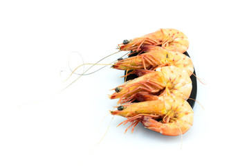 Boiled shrimp and  black plate on white background