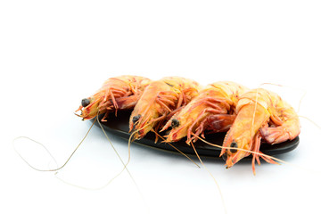 Boiled shrimp and  black plate on white background