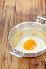 fried meat with sauce and fried egg in dish