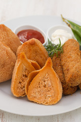 portuguese appetizers with sauces on white plate on white background