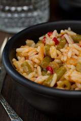 rice with vegetables in white bowl and glass of water